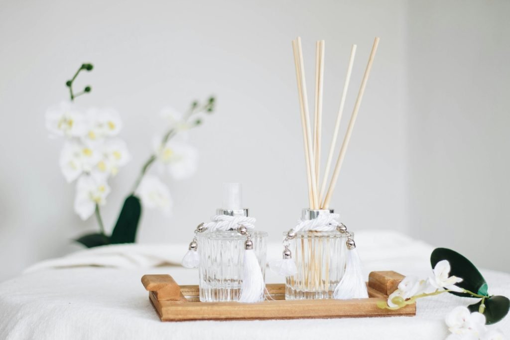 A calm, warmly lit living room prepared for a home spa session